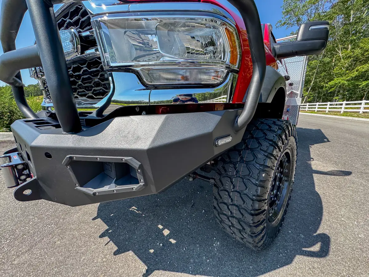 Head-on grille close-up showing emblem and grille guard bars.